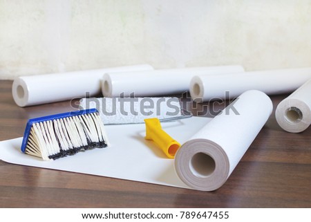 preparation for home repair, wallpaper rolls and brush on the floor Royalty-Free Stock Photo #789647455