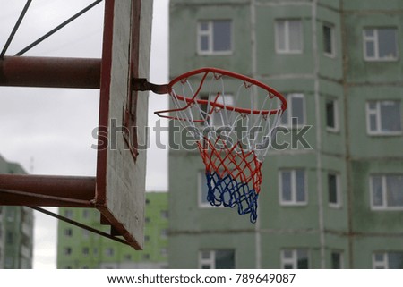 An old basketball ring on the playground. Sports autumn background