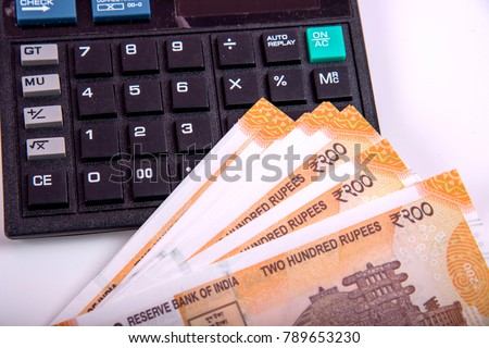 Success and got profit from business with new series of 200 indian rupee currency,money and calculator isolated on white background. 