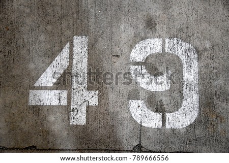 49 stencil number on concrete for parking spot forty nine