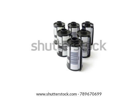 Six old 35mm film cartridges isolated on a white background