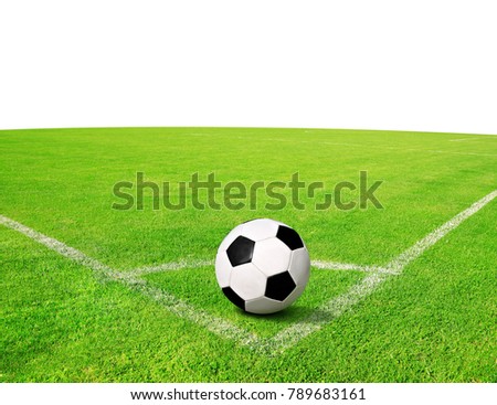 Soccer ball on green grass with copy space on the background.