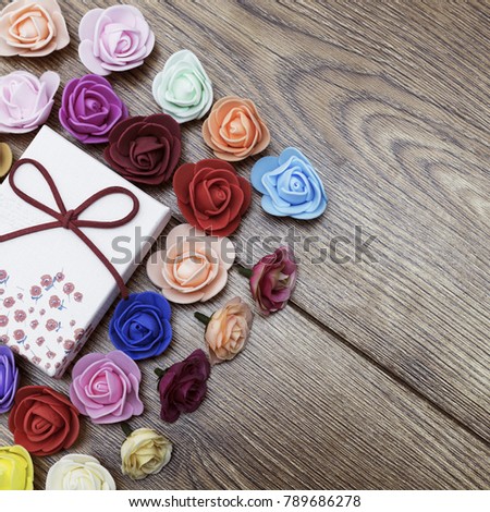 Symbol of Valentine's day. Gift box with group of roses over wooden table.Top view with.