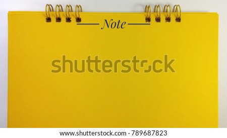 Loop wire binding Yellow book on isolated white background
