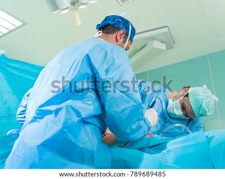 Real surgery team in the operating room. Photos from a live session of breast augmentation surgery.