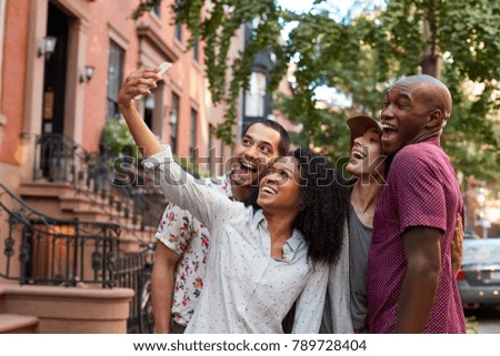 Group Of Friends Posing For Selfie On Street In New York City