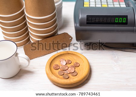 Cash register and wooden cash tray holder in the coffee