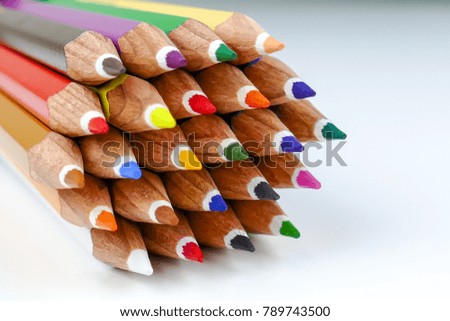 Colour pencils rainbow style, multicoloured pencils on white background. Close up. Selective focus.
