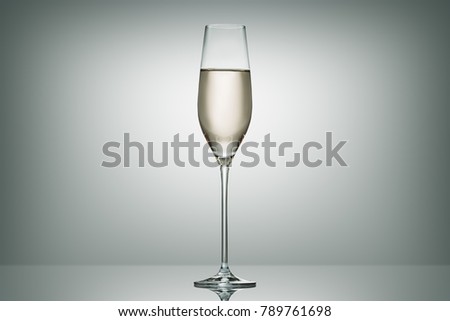 one glass with calm champagne on white