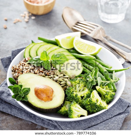 Green vegan lunch bowl with quinoa, green beans, broccoli and avocado