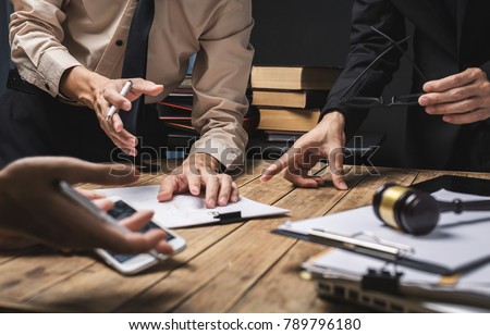 Teamwork of business lawyer meeting working hard about legal regislation in courtroom to help their customer. Royalty-Free Stock Photo #789796180