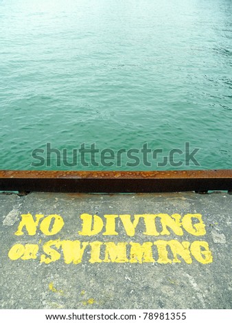No diving or swimming stencil on concrete pier