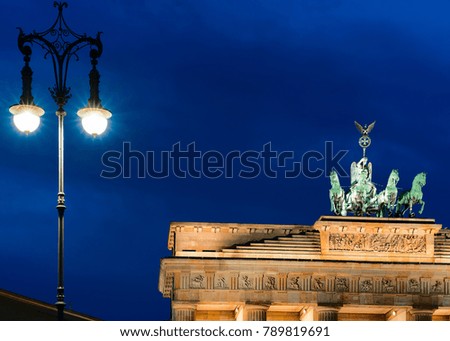 Street lamp and Brandenburg Gate in the center of Berlin late in the evening, Germany