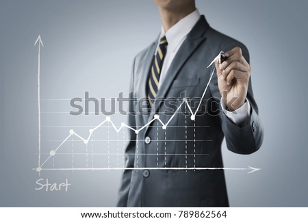 Business growth, progress or success concept. Businessman is drawing a growing graph on bright tone background.