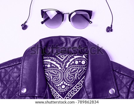 biker jacket and woman sunglasses with headphones on pink background. Alternative fashion set. Flat lay, top view. ultra violet color. Royalty-Free Stock Photo #789862834