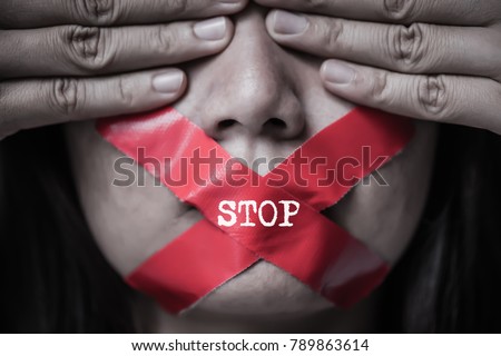 Young woman was wrapping her mount by adhesive tape,  Concept freedom of speech, censorship, freedom of press. International Human Right day. Royalty-Free Stock Photo #789863614