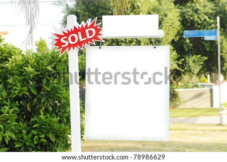 house for sale and sold sign