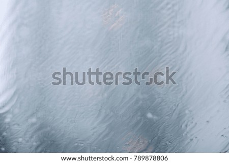 Rain background on car glass at window.