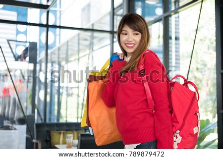asian woman holding many shopping bags. shopaholic, sale, consumerism and people concept