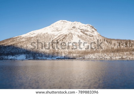 snow-covered mountain from a frozen lake
