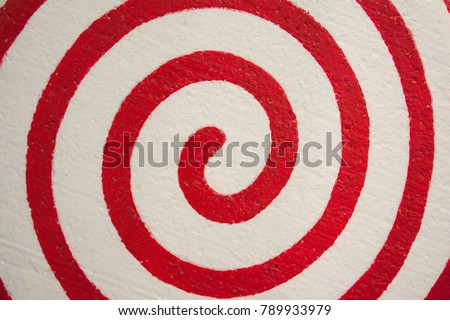 Red swirling radial background. 