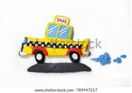 Plasticine yellow taxi car driving on gray road with shadow on white background