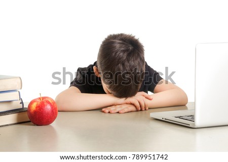 Young tired student taking a nap in front of laptop