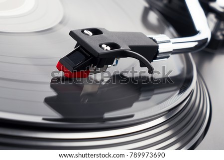 Turntable vinyl record player. Sound technology for DJ to mix & play music. Needle on a vinyl record close-up. Vinyl record player on a background decorations for a party, bright disco lights         