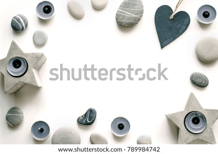 Composition with hearts, candles and sea pebbles on a white background. Love Background for the presentation of work or text. Concrete candlestick. Top view. Copy space. Mock-up