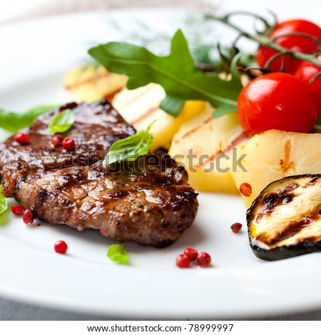 Gourmet grilled steak flavoured with pink pepper and basil. Concept for a tasty and healthy meal.  Royalty-Free Stock Photo #78999997
