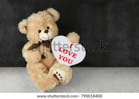 Teddy bear with red hearts wishes you a happy Valentine's day