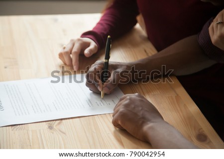 African american man signing contract, black man hand putting signature on official document, biracial clients customers couple make purchase or sign prenuptial agreement concept, close up view