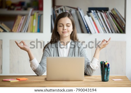 Calm woman relaxing meditating with laptop, no stress free relief at work concept, mindful peaceful young businesswoman or student practicing breathing yoga exercises at workplace, office meditation Royalty-Free Stock Photo #790043194