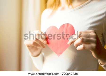 Woman holding red paper heart. Love and Valentines day concept