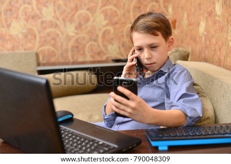 Angry man having problems on line with a laptop talking on the mobile phone with support service sitting on a couch in the living room at home Royalty-Free Stock Photo #790048309