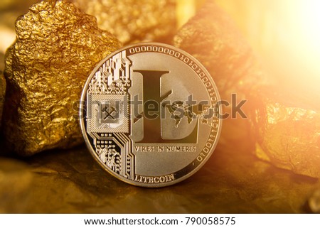 The physical version of Litecoin, the new virtual money. Conceptual image of global crypto currency and digital payment system, gold nuggets, gold stones.