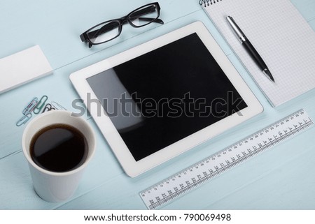 Business workplace supplies with tablet pc on wooden table