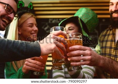 Group of Friends Celebrating St Patrick's Day in Beer Pub Royalty-Free Stock Photo #790090297