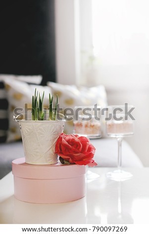 beautiful photo of spring centerpiece with pink rose and daffodil flowers on white table