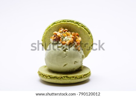 Pistachios macaroons with mint ice cream ball and nuts. French menu. Restaurant. Royalty-Free Stock Photo #790120012