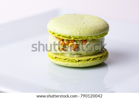 Pistachios macaroons with mint ice cream ball and nuts. French menu. Restaurant. Royalty-Free Stock Photo #790120042