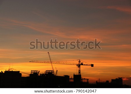 Silhouette construction  and crane sunset background  sky gold color in the evening time