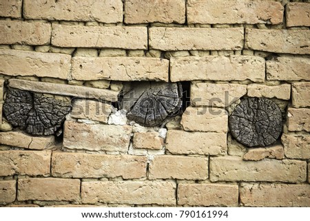 The background picture of the old brick and log wall, the house's wall in Nepal