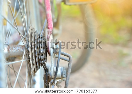 Old bicycle gears of mountain bike with sun light in the morning. Selective focus.