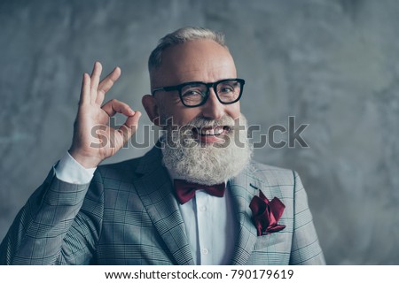 Close up portrait of funny excited cheerful with groomed stylish moustache hipster grandfather sharp-dressed checkered jacket burgundy tissue in pocket making ok symbol isolated on grey background