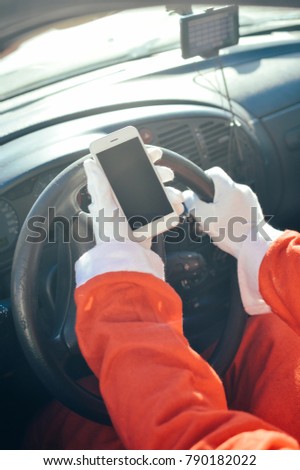 Closeup on driving car Santa Claus using smartphone mockup top view. Joyful tradition celebration, busy season delivering time, outdoors window. Selfy service modern online connection background
