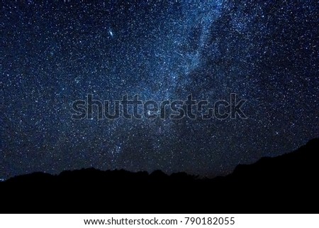 The mountain peaks at night are Milky Way and the stars are full of beautiful night sky.