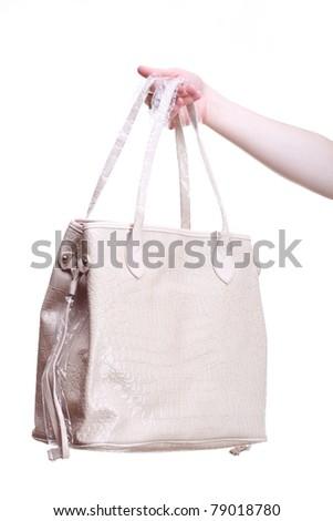 Handbag in woman hand isolated on white