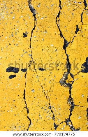 Close up of 
yellow wall texture with cracks, with vibrant colors for creativity, imaginative backgrounds and ideas. Suitable for print, web, postcards, posters, flyers.
