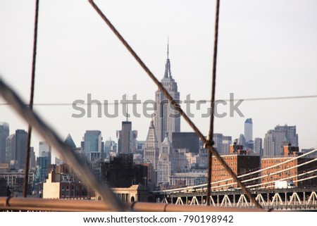 New York skyline view with the Empire State from the Brooklyn Bridge.